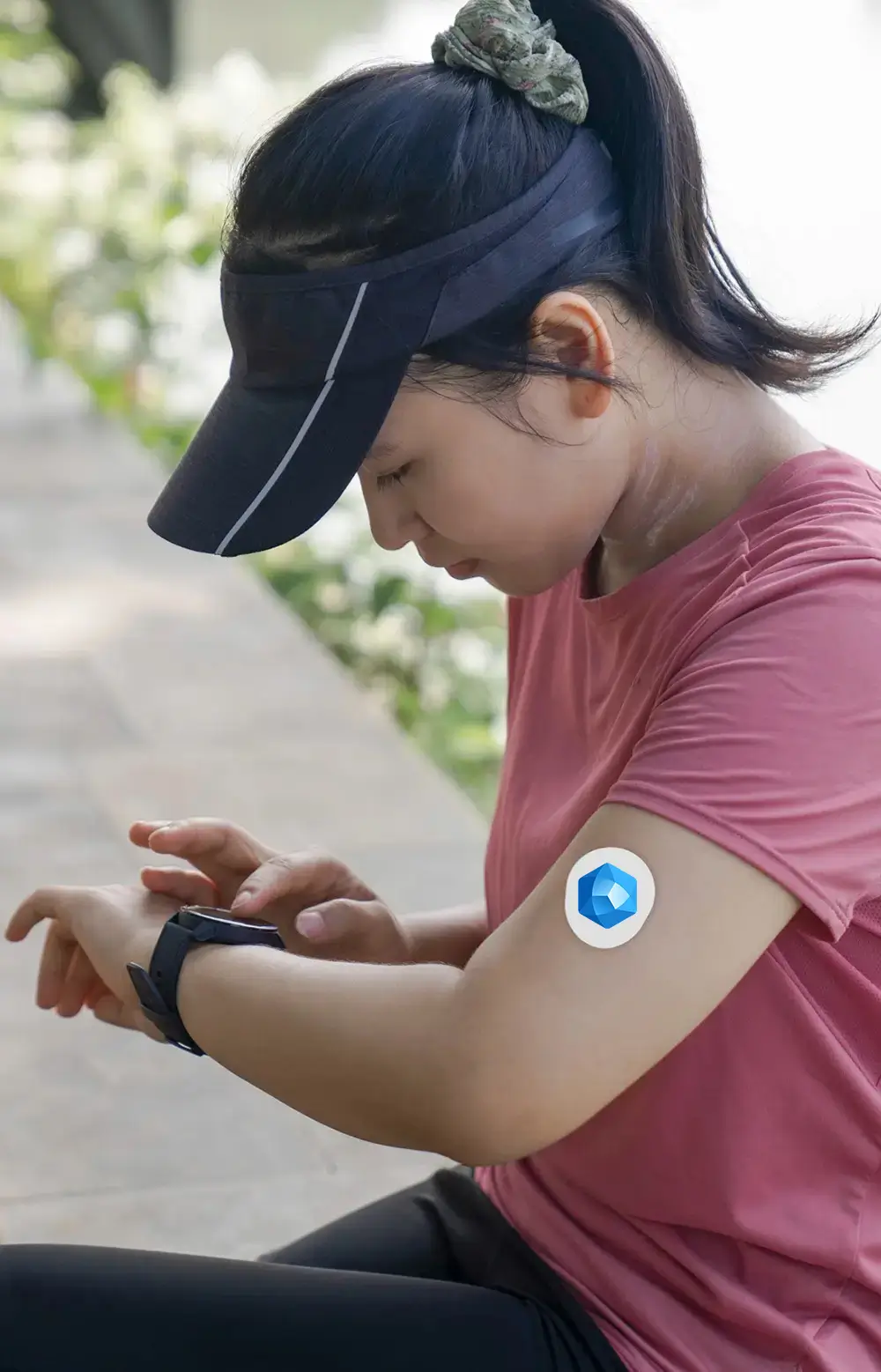 Woman monitoring her blood sugar with a CGM device