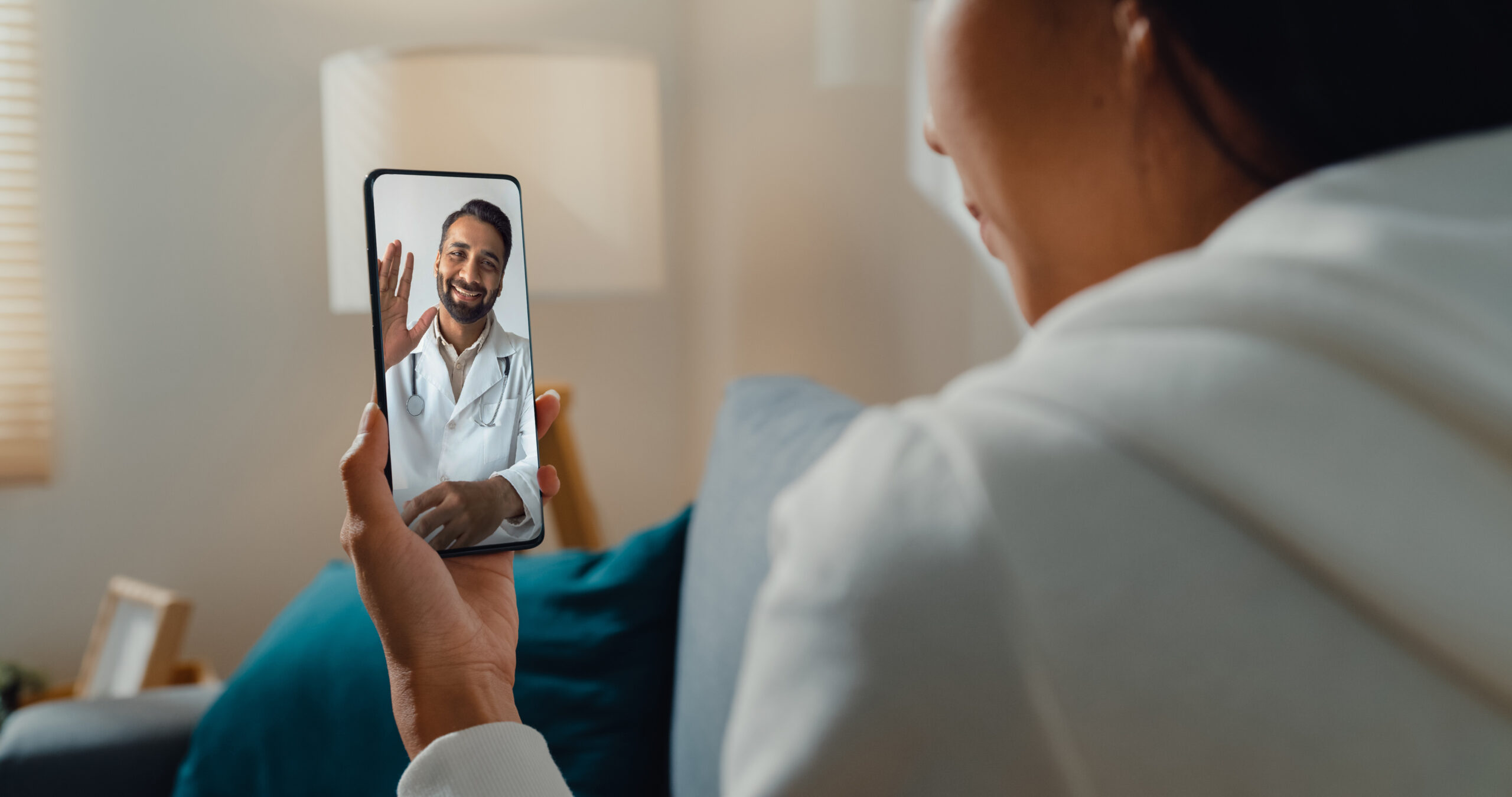 woman consulting a doctor online about diabetes via telemedicine video call on smartphone indoors