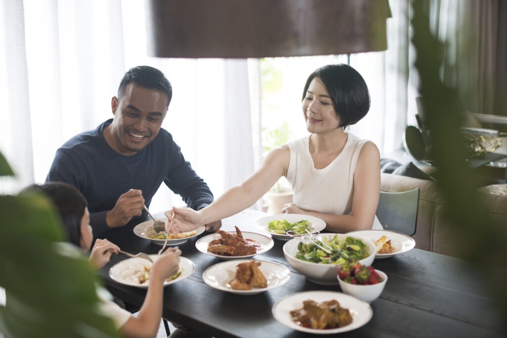 Family sharing a healthy balanced meal with vegetables and protein-rich foods for better nutrition