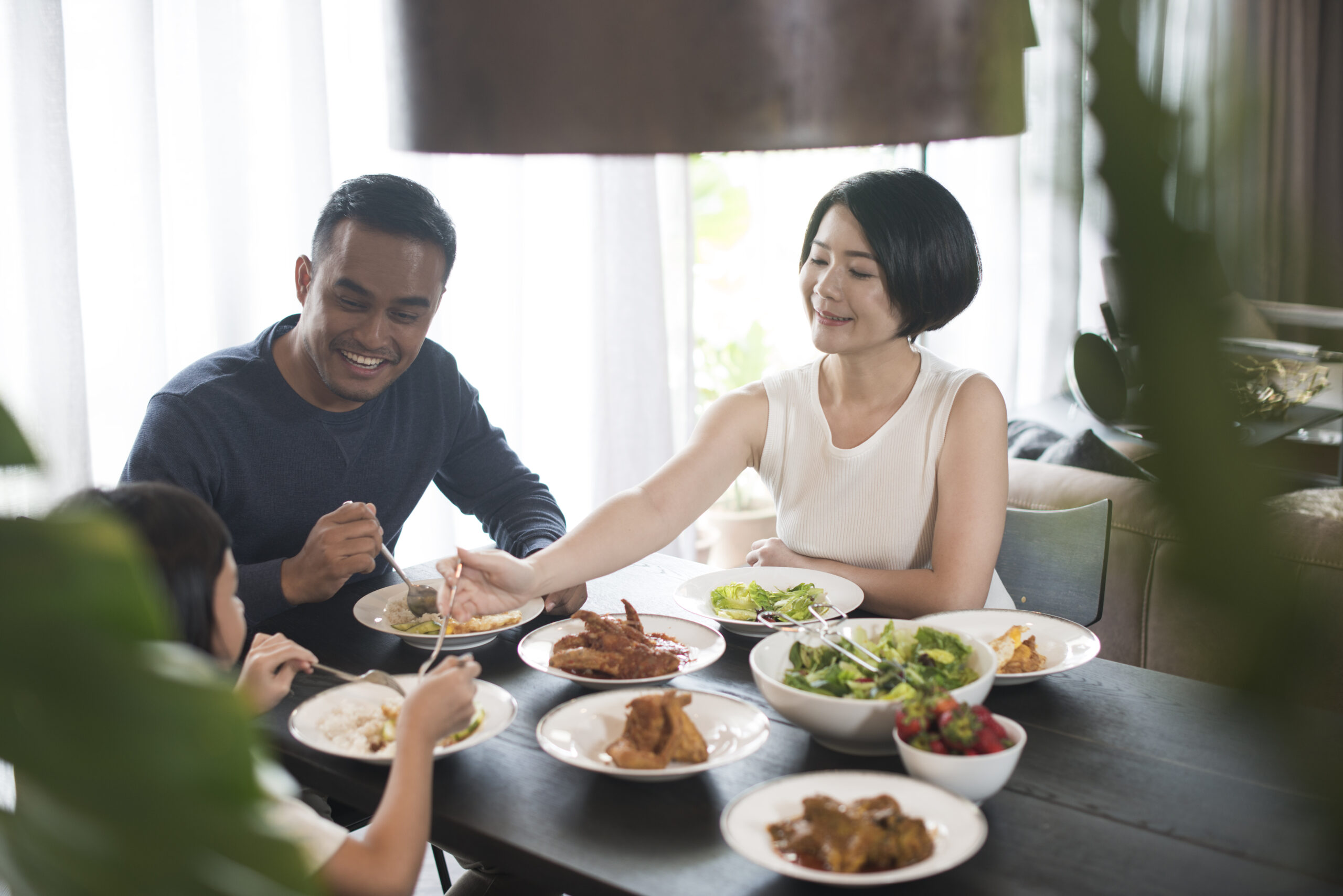 Family sharing a healthy balanced meal with vegetables and protein-rich foods for better nutrition