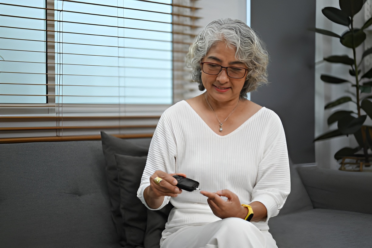 Elderly woman checking blood sugar