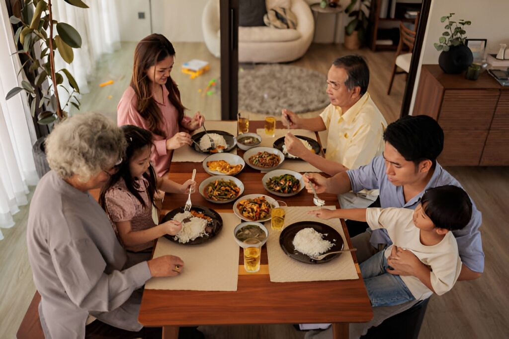 Family eating a balanced home-cooked meal for diabetes nutrition management.
